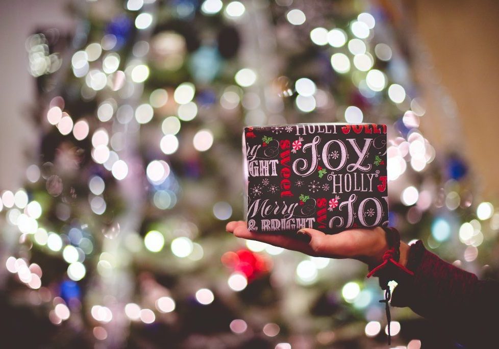 selective focus photography of gift box on person's palm
